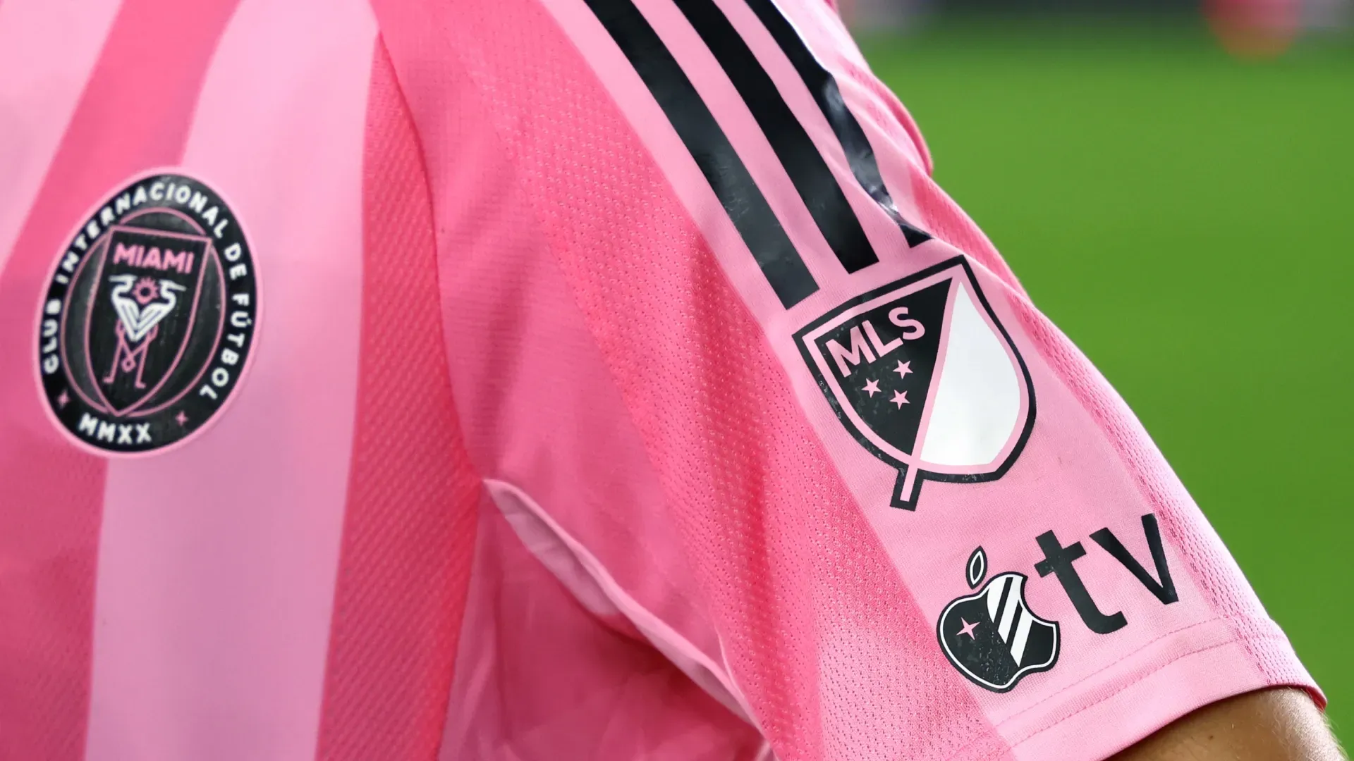 A detailed view of the Apple TV and MLS logo on an Inter Miami CF jersey.