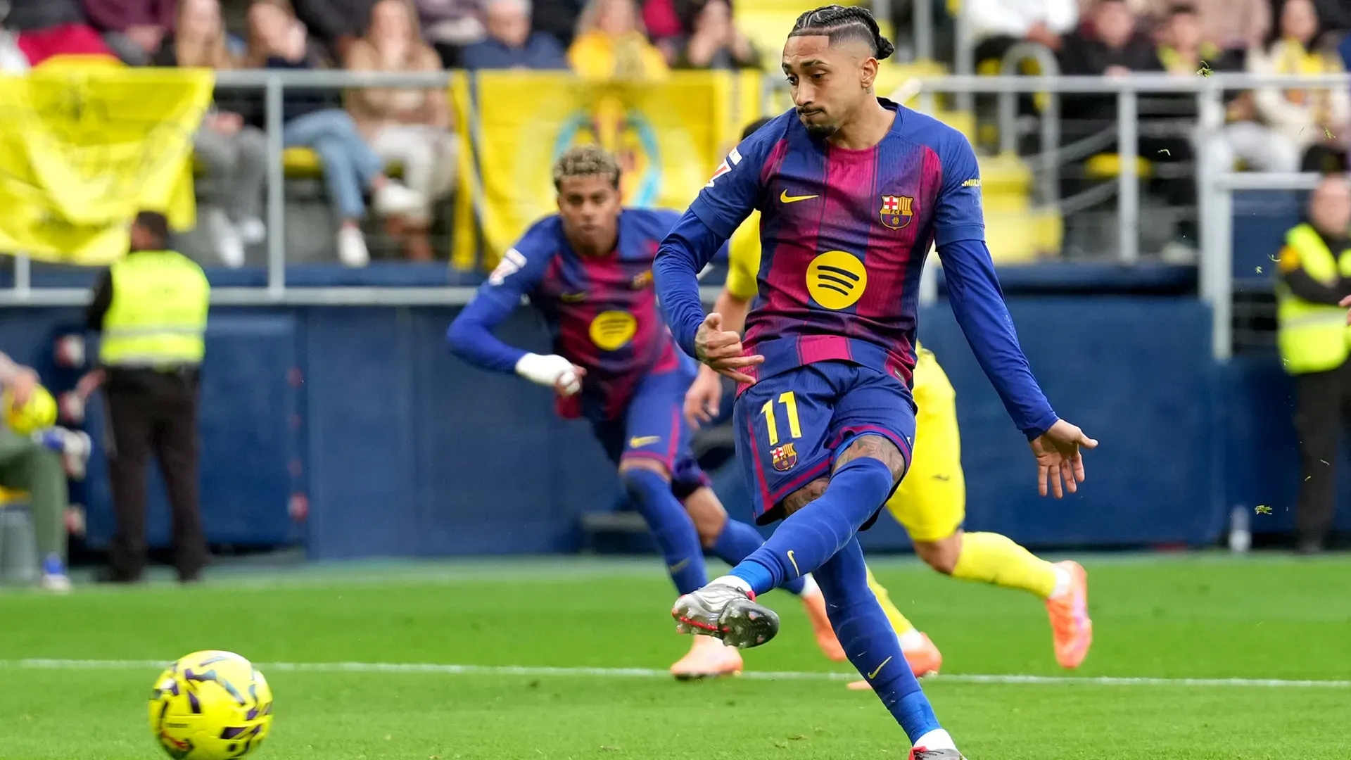 Raphinha of FC Barcelona scores from the penalty spot against Villarreal.