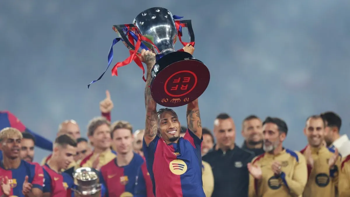 Raphinha of FC Barcelona lifts the La Liga trophy.