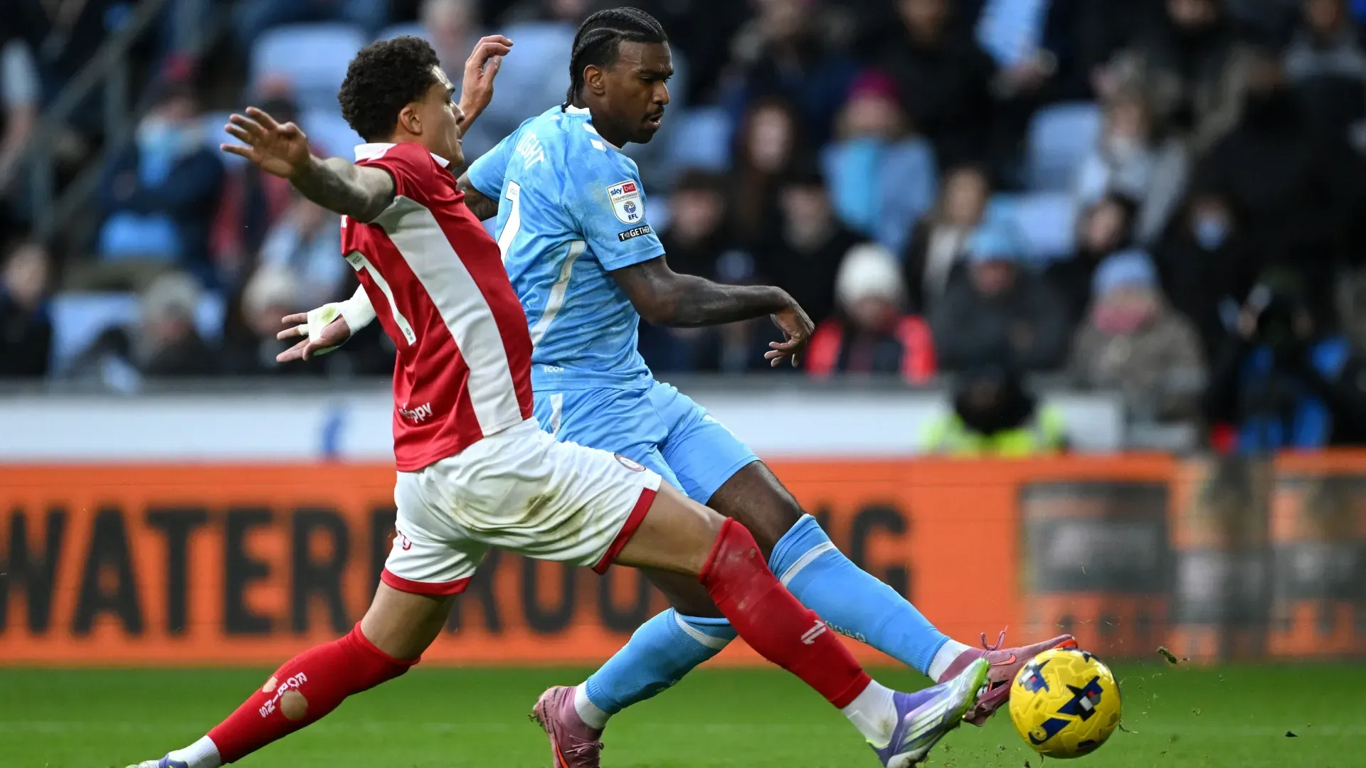 Haji Wright of Coventry City shoots past Neto Borges of Bristol City challenge for the ball.