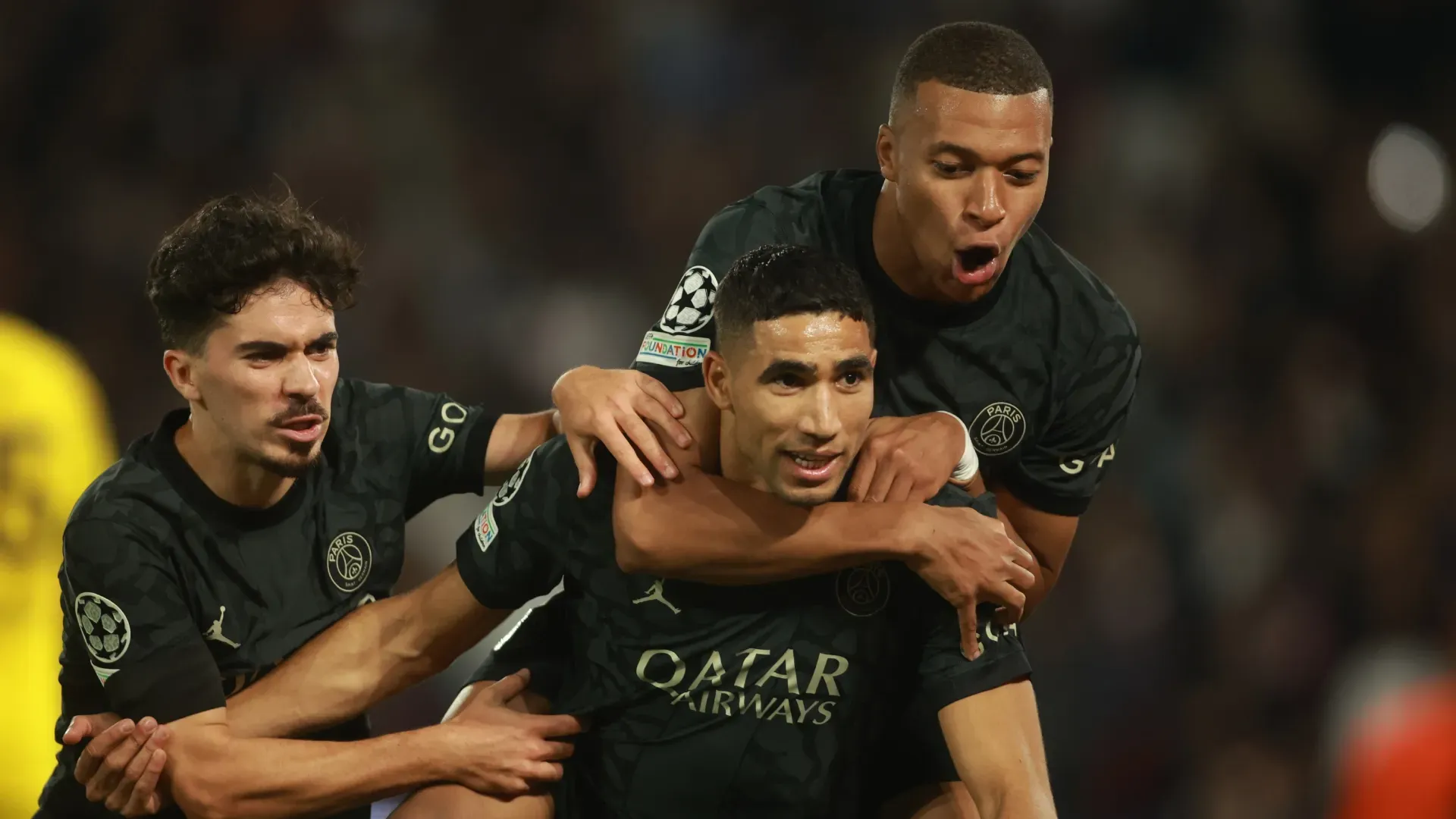 Achraf Hakimi of Paris Saint-Germain celebrates with Vitinha and Kylian Mbappe of Paris Saint-Germain.