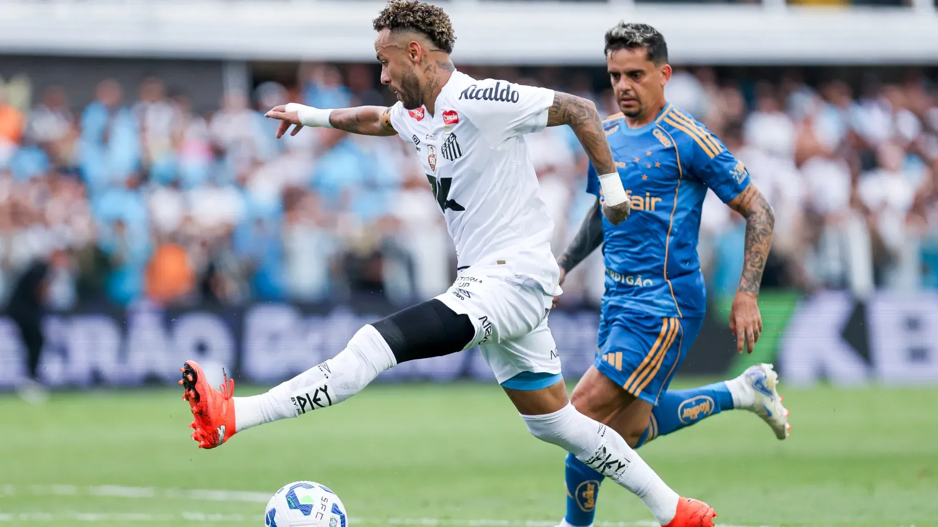 Neymar Junior of Santos runs with the ball in front of Fagner of Cruzeiro with his knee protected.